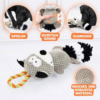 Ein verspielter schwarzer Hund interagiert mit einem Plüschspielzeug, umgeben von bunten Seilspielzeugen. Der Text hebt hervor: 'SCHMUSEN' und 'WEICHES UND ROBUSTES MATERIAL.'