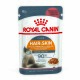 Royal Canin Hair & Skin cat food pouch, 85g, featuring a fluffy cat, with text highlighting support for healthy skin and shiny coat.