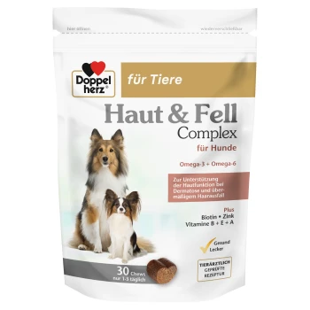 Hundesupplement-Verpackung mit zwei Hunden auf der Vorderseite, beschriftet mit "Haut & Fell Komplex für Hunde," mit Details zu Omega-3, Omega-6 und Vitaminen.
