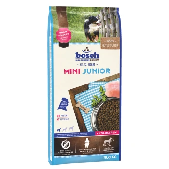 Bosch Mini Junior Hundefuttertüte, 15 kg, mit einem Welpen auf der Vorderseite, mit Text, der 26% Protein, 17% Fett und 'Kolosrum' hervorhebt.