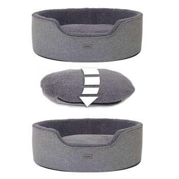 Graues Haustierbett mit einem plüschigen Innenraum, mit einem abnehmbaren oberen Kissen, beschriftet "lionte."