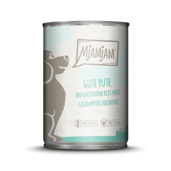 Dose mit Hundefutter mit einer grauen Hundesilhouette, beschriftet "Mjamjam Gute Pute", glutenfrei, fleischreich, mit Reis und Zucchini.