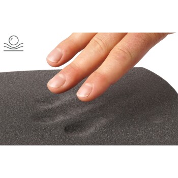 Eine Hand drückt sanft auf eine strukturierte schwarze Oberfläche, wodurch sichtbare Eindrücke entstehen, die die Weichheit des Materials zeigen.