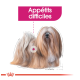 Illustration d'un chien duveteux avec un pelage long et fluide, étiqueté "Appétits difficiles" en texte rose gras.