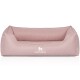 Ein weiches rosa Hundebett mit erhöhten Seiten und einem weißen "KNUFFELWUFF"-Logo auf der Vorderseite, entworfen für den Komfort von Haustieren.