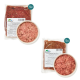 Zwei Pakete Hundefutter, eines mit der Aufschrift "Lammischung" und das andere "Rindermuskel", mit einer Schüssel rohem Fleisch in der Mitte.