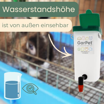 Weißer GarPet-Wasserspender mit grünem Deckel und roter Düse; sichtbarer Text 'Wasserstandshöhe ist von außen einsehbar', unscharfer Hase im Käfig.