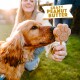 Un golden retriever renifle avec enthousiasme une friandise en forme de patte au beurre de cacahuète tenue par une personne, avec le texte 'CRAZY PEANUT BUTTER' au-dessus.