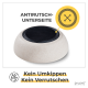 Rutschfeste Haustierschüssel mit einer strukturierten schwarzen Oberfläche und beigem Boden, mit dem Text: "Antirutsch-Unterseite" und "Kein Umkippen Kein Verrutschen."