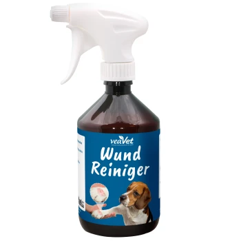 Eine braune Sprühflasche mit der Aufschrift 'veaVet Wund Reiniger' und einem weißen Sprühkopf, mit einem Bild eines Beagles und einer Hand, die das Produkt anwendet.