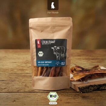Kraftbeutel mit Aufschrift „LIEBESGUT“ und Kuh-Illustration; mit der Aufschrift „Für Hunde“ und „Bio-Rind Kopfhaut“. Sichtfenster zeigt getrocknete Rindfleisch-Hundesnacks.