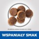 Zbliżenie na okrągłe kawałki granulatu karmy dla zwierząt, z odniesieniem do rozmiaru około 5,5 x 13 mm, oraz tekstem 'WSPANIAŁY SMAK' na dole.
