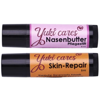 Zwei Pflegebalsame für Haustiere von "Yuki cares": eine pinke Tube mit der Aufschrift "Nasenbutter Pflege-stift" und eine orangefarbene Tube mit der Aufschrift "Skin-Repair", beide 5 ml.