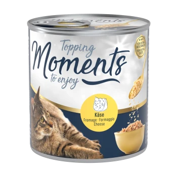 Une boîte de nourriture pour chats étiquetée "Moments Topping à savourer," présentant un chat tigré et un bol de nourriture, avec "Käse" (fromage) mis en avant.