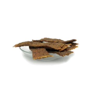 Ein Glasplatte gefüllt mit mehreren Stückchen brauner, knuspriger Haustier-Leckerlis, die wie Jerky aussehen und ungleichmäßig gestapelt sind.