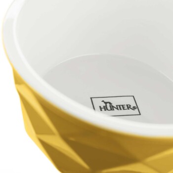 Gelbe geometrische Futterschüssel für Haustiere mit weißem Innenraum, mit dem Logo "HUNTER" am Boden gedruckt.