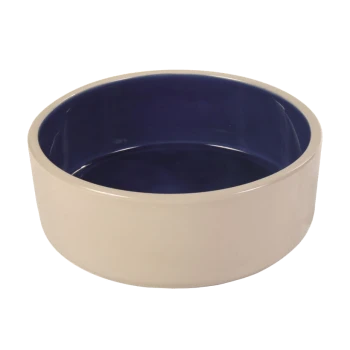 Bol en céramique pour animaux avec un extérieur crème et un intérieur bleu profond, présentant un design lisse et rond.