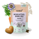 Ein Paket "Wohlfühl Snacks" für Hunde, entworfen zur Linderung von Stress und Angst, umgeben von einer Karotte, einer Kartoffel und Kräutern.