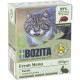 Eine Box mit Bozita Fresh Menu Katzenfutter, bei dem Kaninchen die Hauptzutat ist, mit einer Katze, die sich auf der Vorderseite die Lippen leckt.