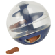 Clear plastic treat-dispensing ball with a blue base, showing a few brown dog treats inside and one on the ground.