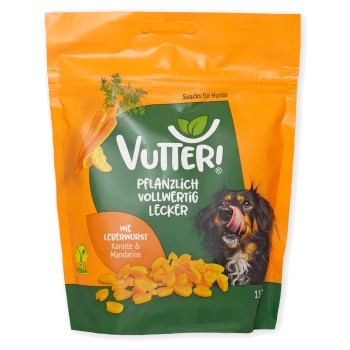 Orange-grüne Verpackung der Vutteri veganen Hundesnacks mit Karotten, Mandarine und einem Hund, der sich die Lippen leckt.