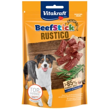 Vitakraft BeefStick Rustico Hundeleckerlis Verpackung mit einem glücklichen Hund, Stückchen von Rindersticks und Text, der 85% Fleisch und zusätzliche Vitamine hervorhebt.