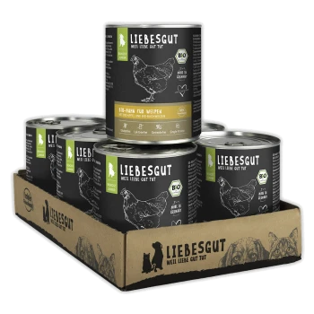 Papptray mit sechs Dosen Hundefutter der Marke Liebesgut mit schwarzen Etiketten, Hühnerillustration und sichtbar 'LIEBESGUT' und 'Bio' Schriftzug.