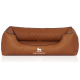Braunes Hundebett mit einem weichen, gepolsterten Design, mit einem schwarzen Rand und dem Logo "KNUFFELWUFF" deutlich sichtbar.