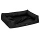 Schwarzes rechteckiges Haustierbett mit erhöhten Rändern und einem weichen Innenraum, mit einem kleinen Kissen auf einer Seite.