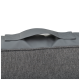 Transporteur pour animaux de compagnie gris avec une poignée robuste, présentant un design en tissu texturé et un dessus lisse semblable à du cuir.