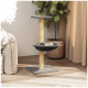 Ein moderner Katzenbaum mit einer grauen Basis, einem gelben Kratzbaum und einer gemütlichen runden Sitzfläche, platziert neben einer Topfpflanze in einem stilvollen Raum.