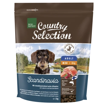 Sac de nourriture pour chiens marron étiqueté "Real Nature Country Selection" avec un fond pittoresque, mettant en avant la saveur "Scandinavie" pour les petits chiens adultes.