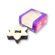 Star-shaped pet cake with creamy top, patterned brown sides and a dark bone-shaped dog treat on top.