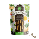 Verpackung für Zahnsnacks mit Algen und Grünkohl, beschriftet mit "100% Veggie" und "100% Irish", mit einem Pfotenabdruck-Design und Gesundheitsansprüchen auf Deutsch.