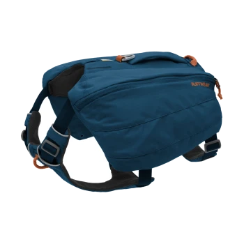 Ein blauer Hunderrucksack von Ruffwear, mit verstellbaren Riemen, einem oberen Griff und einem Reißverschlussfach für die Aufbewahrung.
