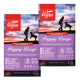 Zwei Säcke Orijen Puppy Large Hundefutter mit lila Design, das Hunde und eine Person zeigt, mit dem Hinweis auf "85% hochwertige tierische Zutaten."
