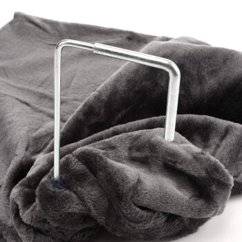 Eine graue Haustierdecke mit einem teilweise eingesetzten Metallrahmen, der ihre weiche Textur und das plüschige Material zeigt.