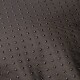 Nahaufnahme einer strukturierten schwarzen Haustiermatte mit erhöhten Punkten für Grip und Komfort, geeignet für Haustiergebrauch.