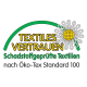 Öko‑Tex-Label 'TEXTILES VERTRAUEN' mit grünem Bogen und Blume; Text: 'Schadstoffgeprüfte Textilien nach Öko‑Tex Standard 100'.