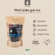Kraftpapierbeutel mit Liebesgut Bio‑Rinderpansen-Hundesnacks mit Kuhabbildung; deutscher Text ‚Für Hunde‘ und ‚Weil Liebe gut tut.‘; Symbole: Glutenfrei, Getreidefrei, Laktosefrei, Single‑Protein, BIO