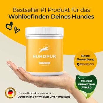 Bestseller-Produkt Nr. 1 für das Wohlbefinden Ihres Hundes, HUNDPUR, in einem gelben Behälter, der in einer Hand gehalten wird, mit "HAUT & FELL" und "Glanzkomplex."