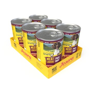 Sechserpack Josera Meat Lovers Pure Beef Hundefutterdosen in einer gelben Schale, Dosen zeigen Hundefoto und 'Meat Lovers'-Etikett.