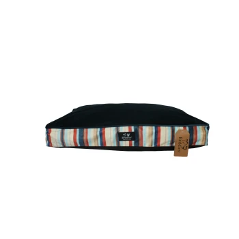 Rectangular pet bed cushion with dark navy top, multicolored striped sides and a 'Beddies' label and hang tag.