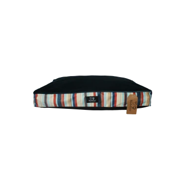Rectangular pet bed cushion with dark navy top, multicolored striped sides and a 'Beddies' label and hang tag.