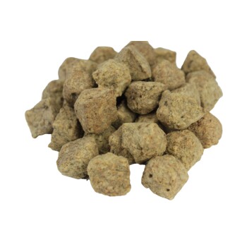 Ein Haufen kleiner, unregelmäßig geformter, bräunlich-grüner Haustierfutterpellets, die eine natürliche, körnige Textur zeigen.