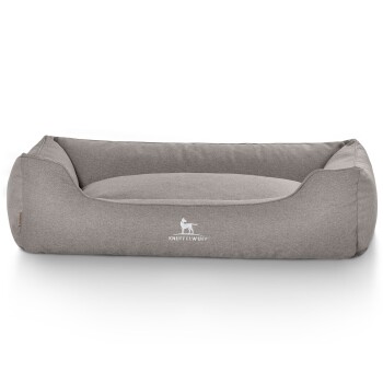 Graues Hundebett mit erhöhten Rändern und einem weichen Zentrum, mit dem Logo "KNUFFELWUFF" in Weiß.