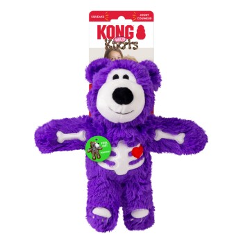 Purple plush bear dog toy with white skeleton patches and red heart, KONG Wild Knots packaging and green "FEEL ME!" sticker.