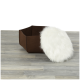 Ein braunes Filz-Haustierbett mit einem abnehmbaren flauschigen weißen Kissen, auf einem hellen Holzboden platziert.