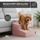 Kleiner brauner Hund auf pinken gerippten Haustiertreppen neben Sofa; deutscher Text 'ERLEICHTERT DEN ALLTAG', ROHRSCHNEIDER.