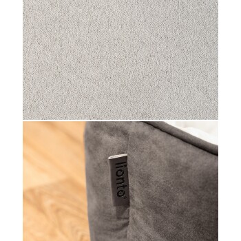 Nahaufnahme eines weichen grauen Haustierbettes mit einem weißen Innenraum und einem Etikett, das den Markennamen "lionto" zeigt.